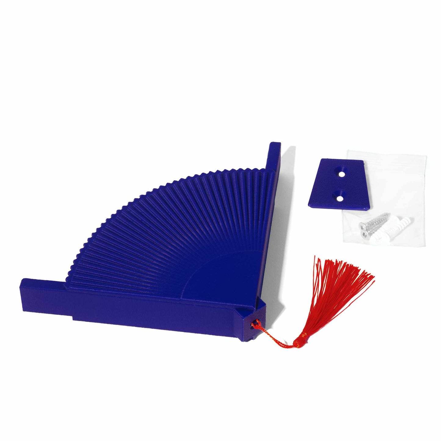 Blue coffee filter holder with a red tassel next to a blue wall attachment and a baggie containing two screws and two plastic anchors on a white background