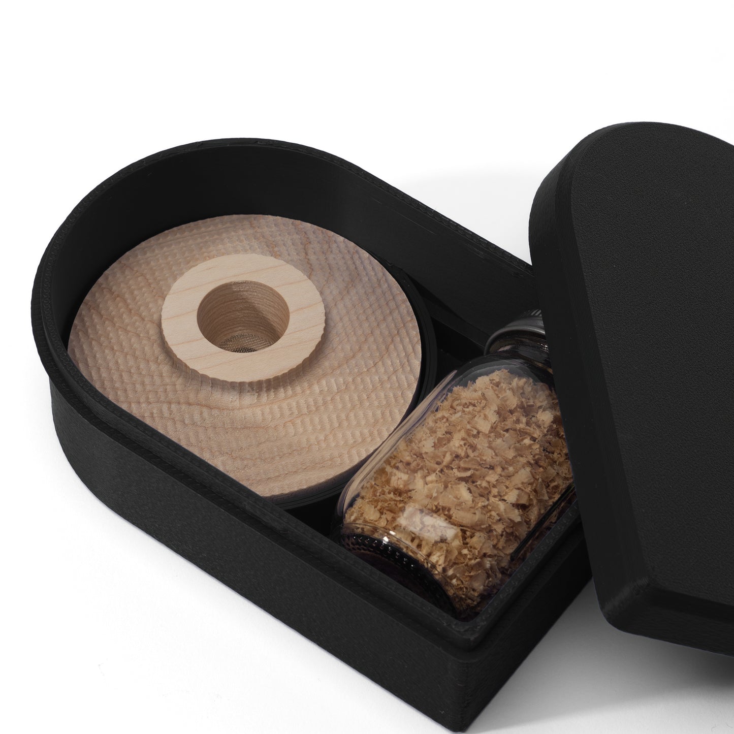 Black 3D Printed container with a wooden cocktail smoker, jar of white oak wood shavings, and a lid for the container displayed on a white background