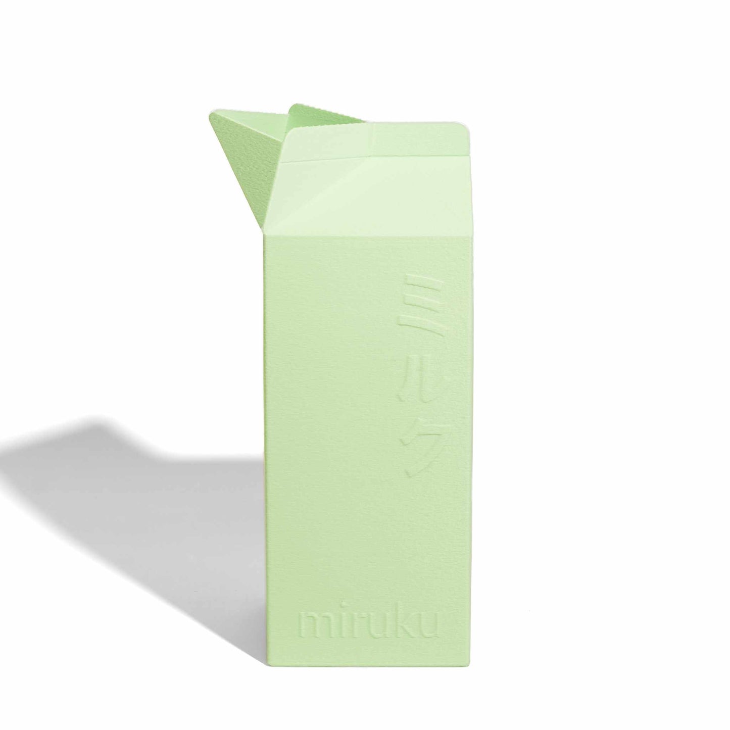 Light green 2L milk carton vase on a white background
