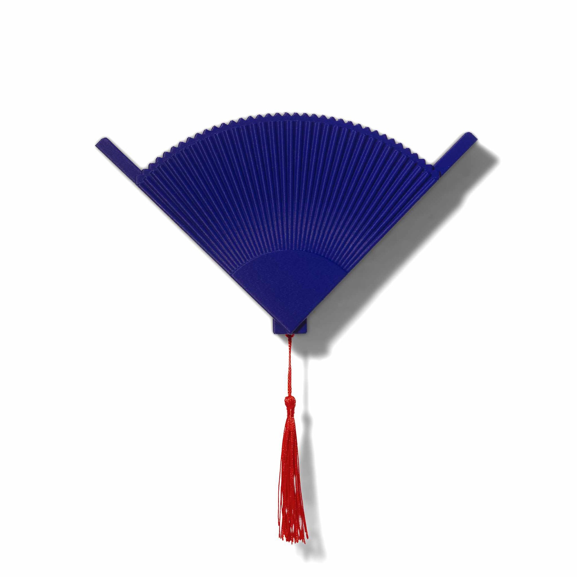 Blue coffee filter holder with a red tassel on a white background