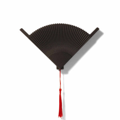 Matte black coffee filter holder with a red tassel on a white background
