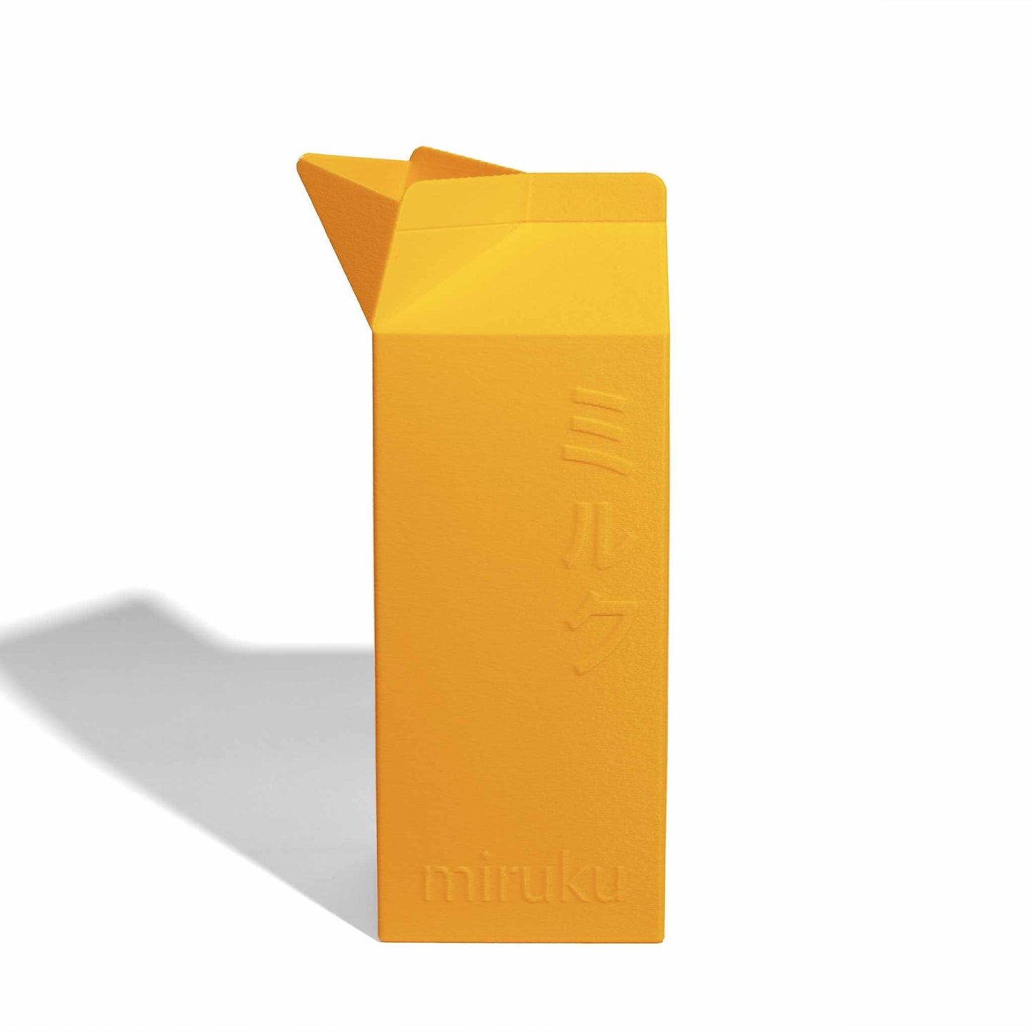 Yellow 2L milk carton vase on a white background