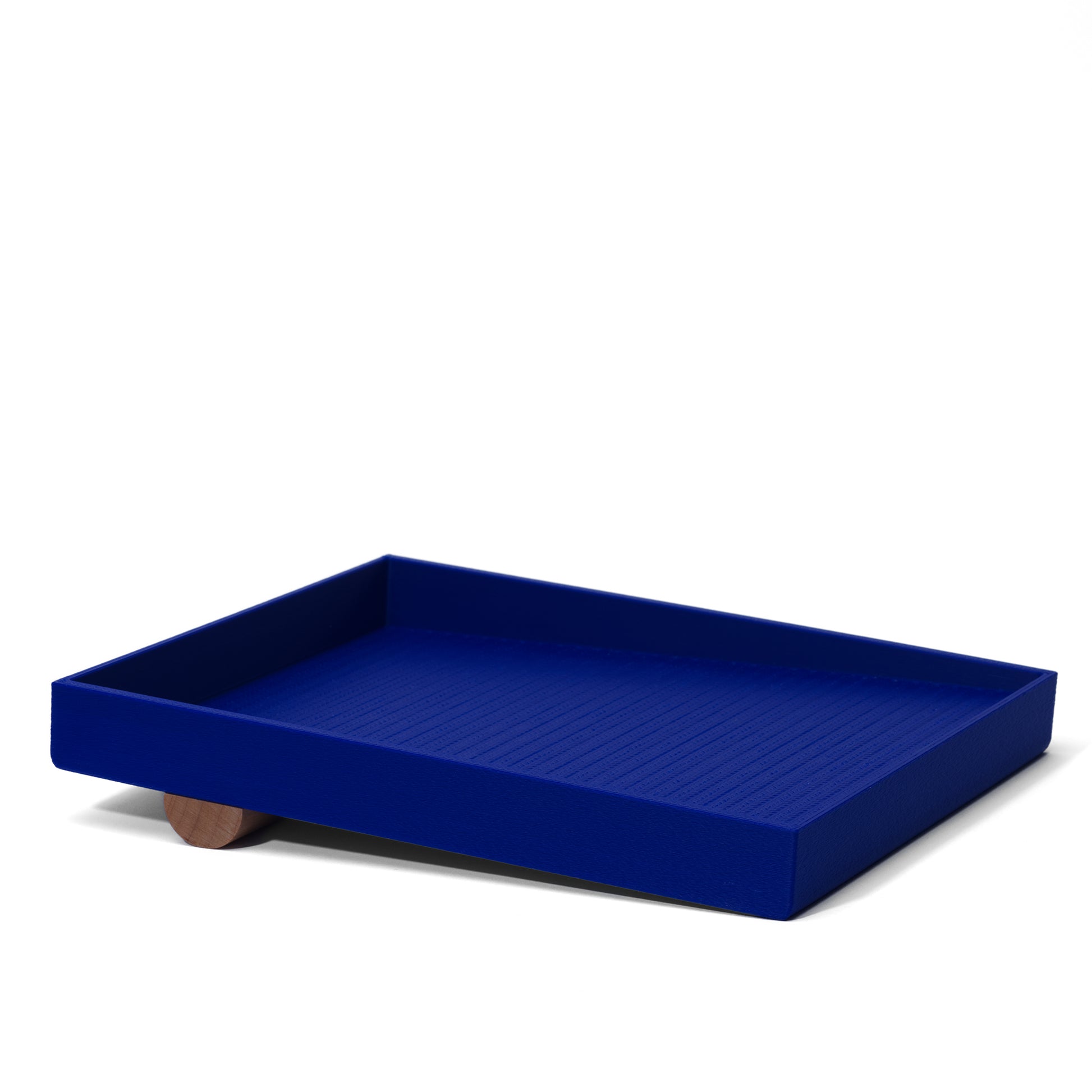 blue catch-all tray with a handcrafted wood dowel base